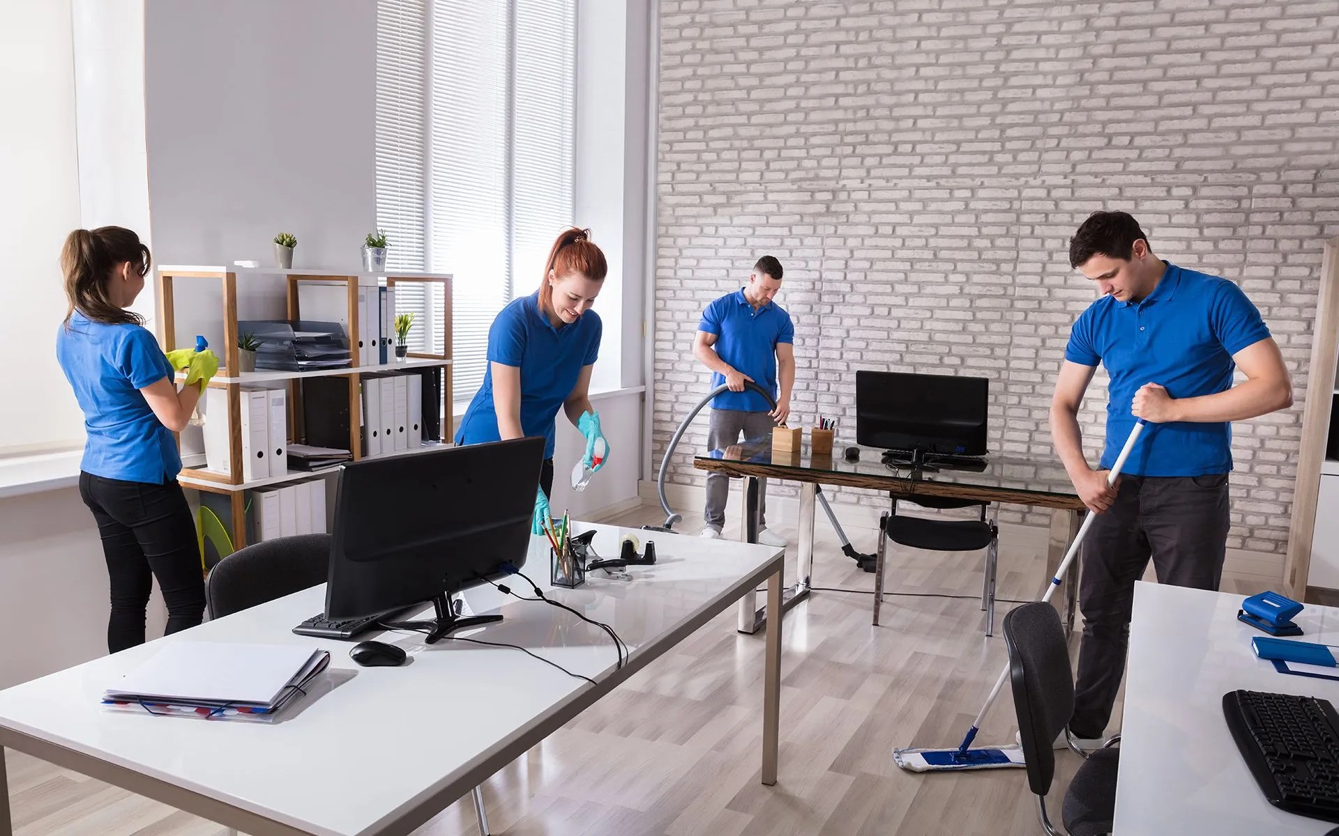 A professional cleaning crew servicing a bright commercial office
